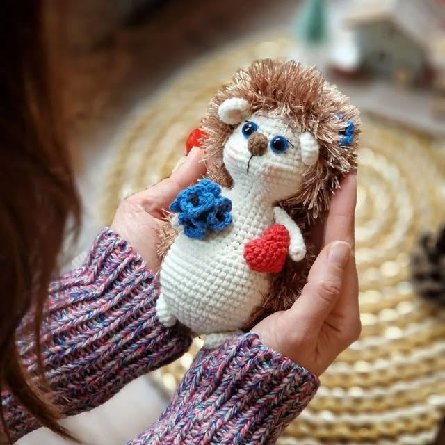 Handmade crochet hedgehog with heart and flowers